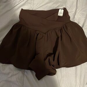 size small Arie cross over shorts brown never worn with tag